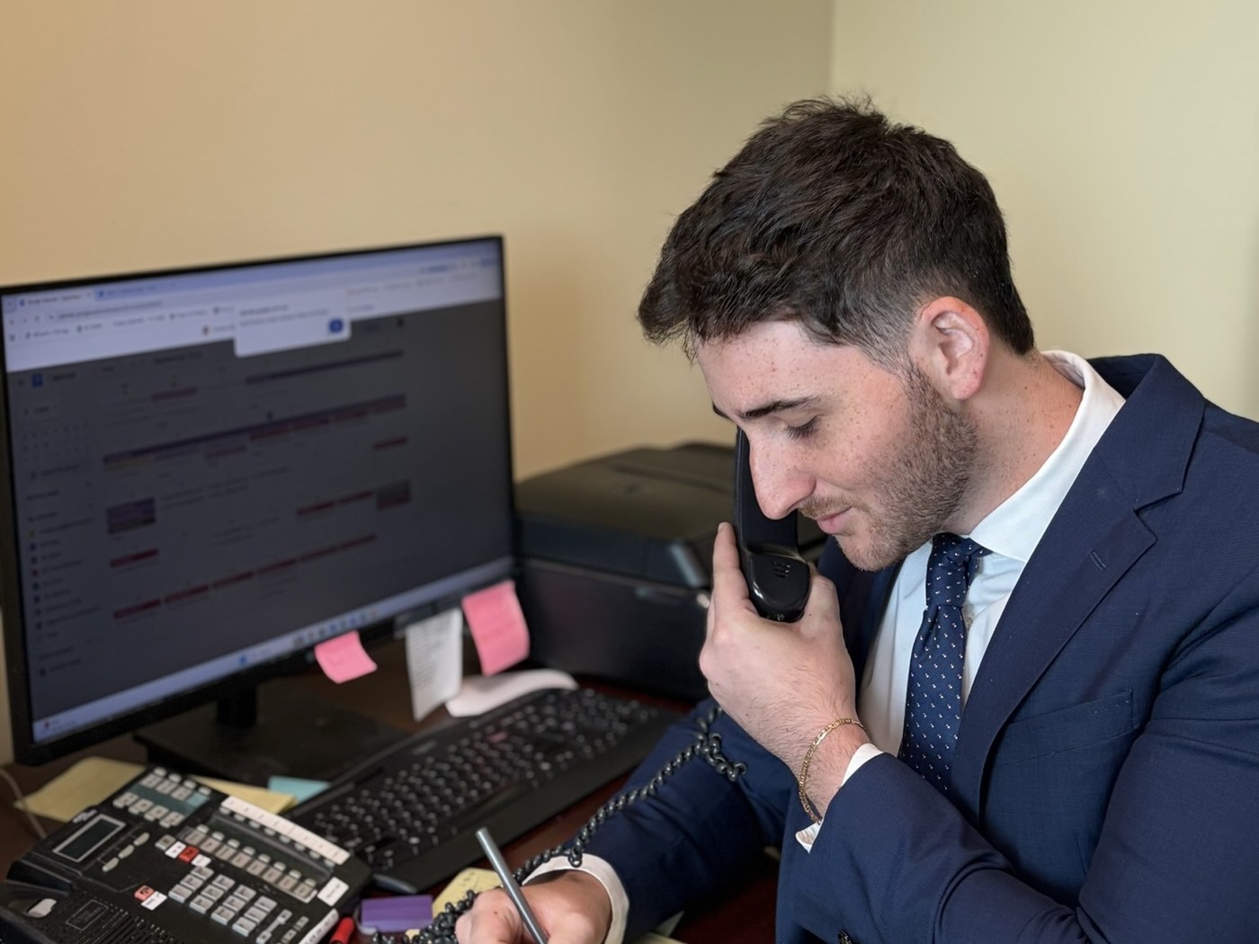 Attorney working at a desk while speaking with a client